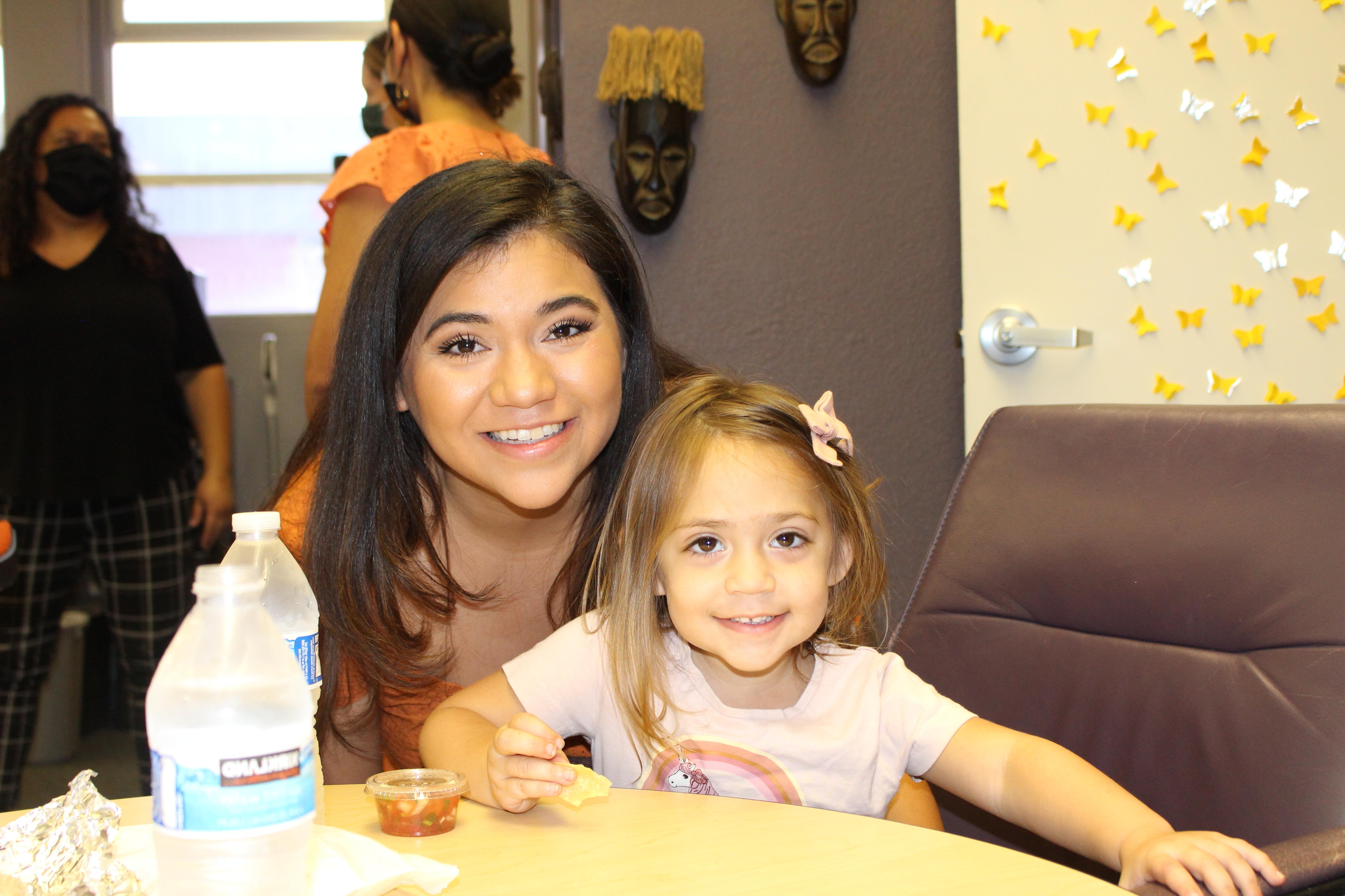 Mom and daughter smile on campus